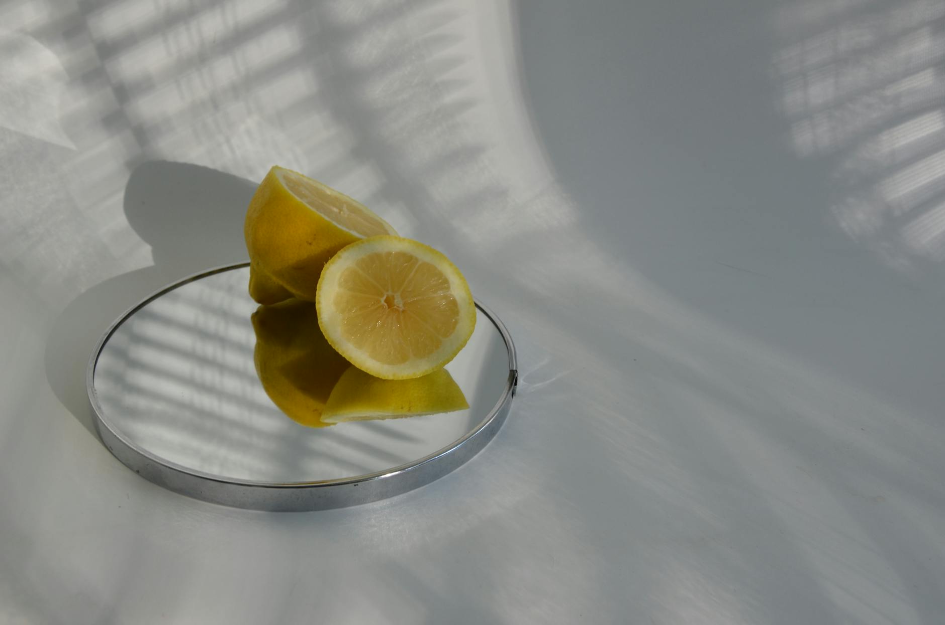 Hand holding a blue lemon suction vibrator against purple background