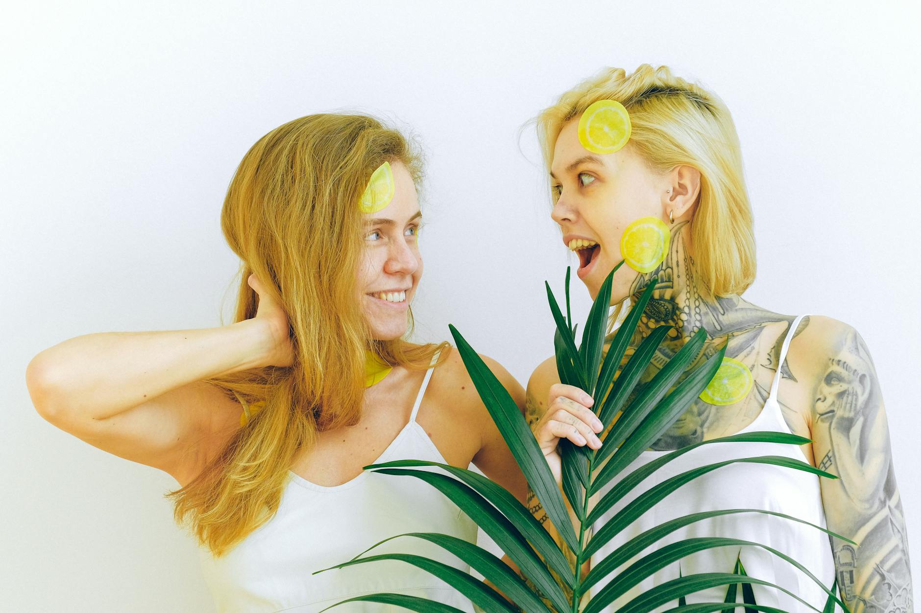 Two women smiling together outdoors, representing trust and connection in intimate relationships