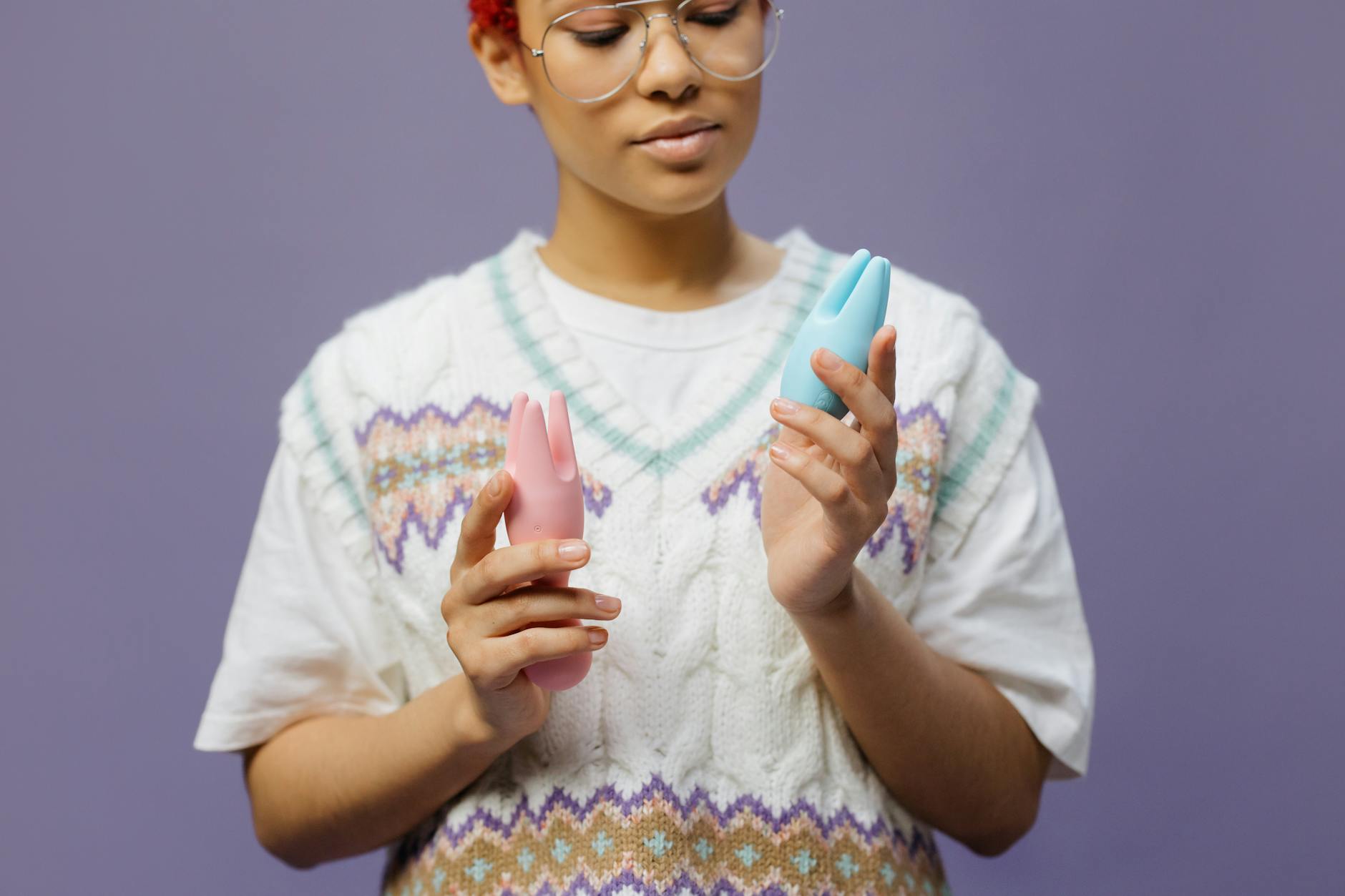 Woman holding lemon clitoral vibrators, considering her options for pleasure with vaginal dryness.