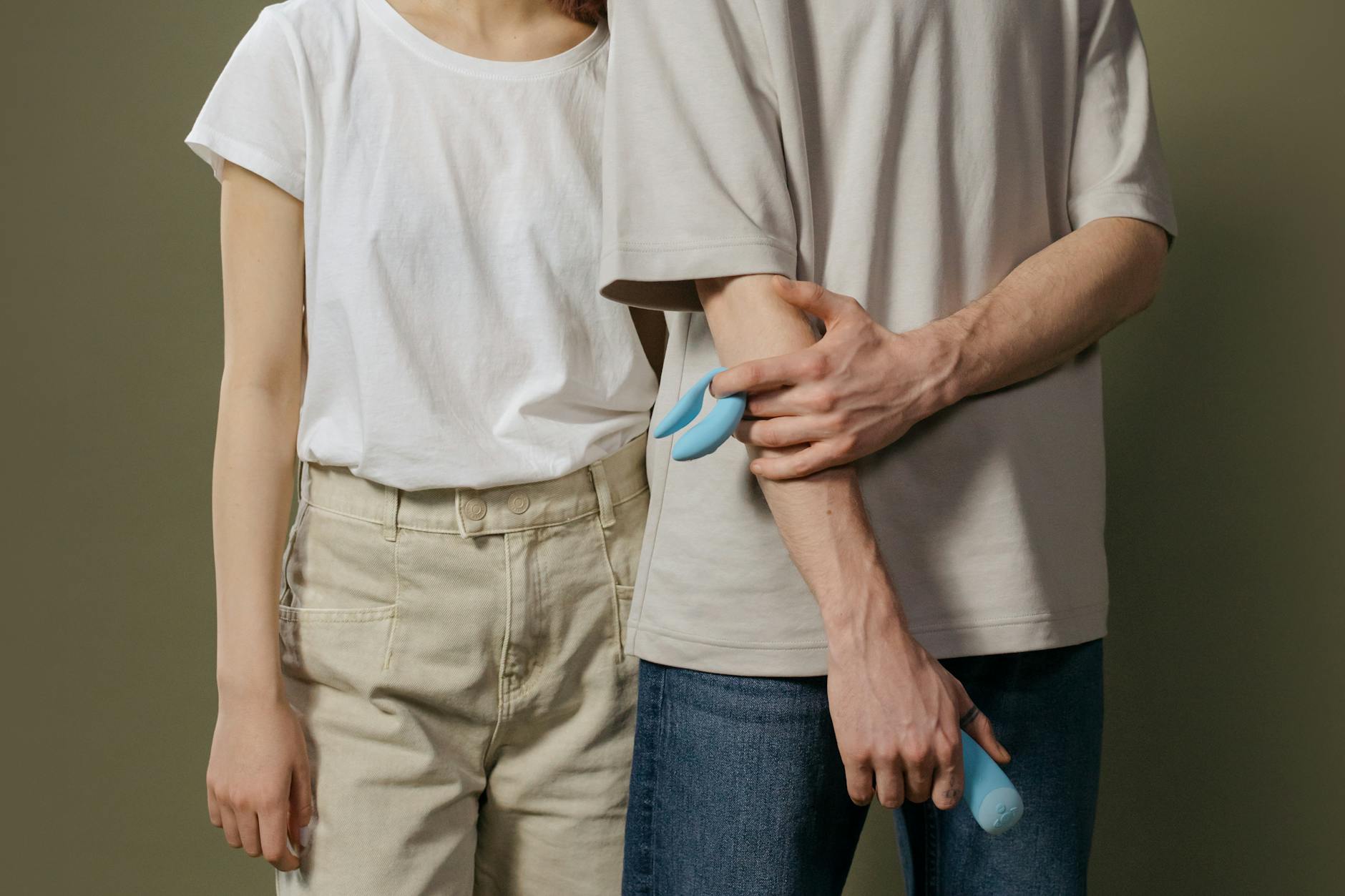A young couple standing together indoors, symbolizing modern intimacy and the shared discovery of pleasure.
